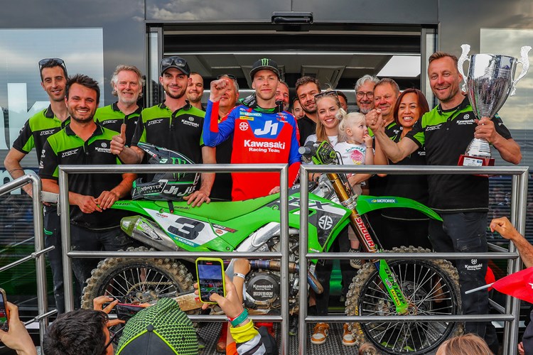 Romain Febvre celebrating with his team on his moto win and podium finish.
